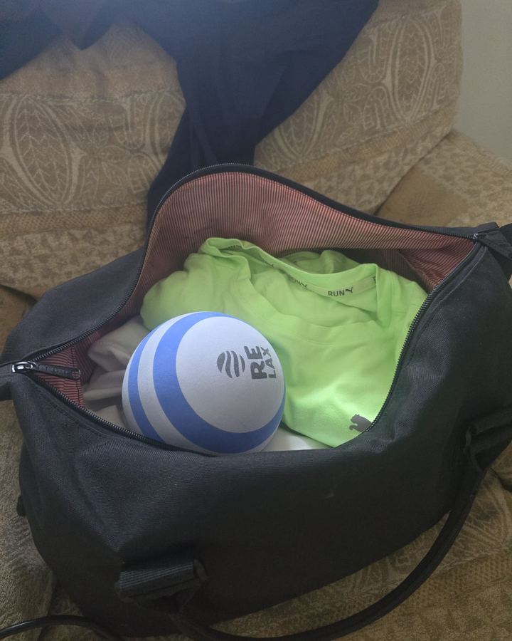 RELAX Massage Ball packed in a gym bag with training gear